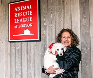 Kim Roderiques holding a puppy outside of ARL Dedham.